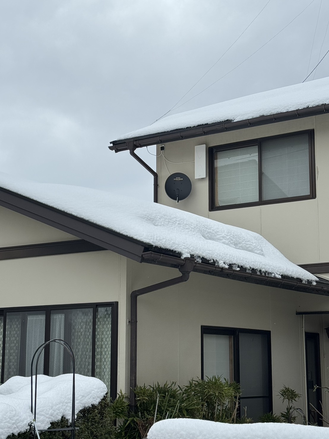 地デジアンテナとBSアンテナを2階壁面に設置した全景（雪のある住宅）