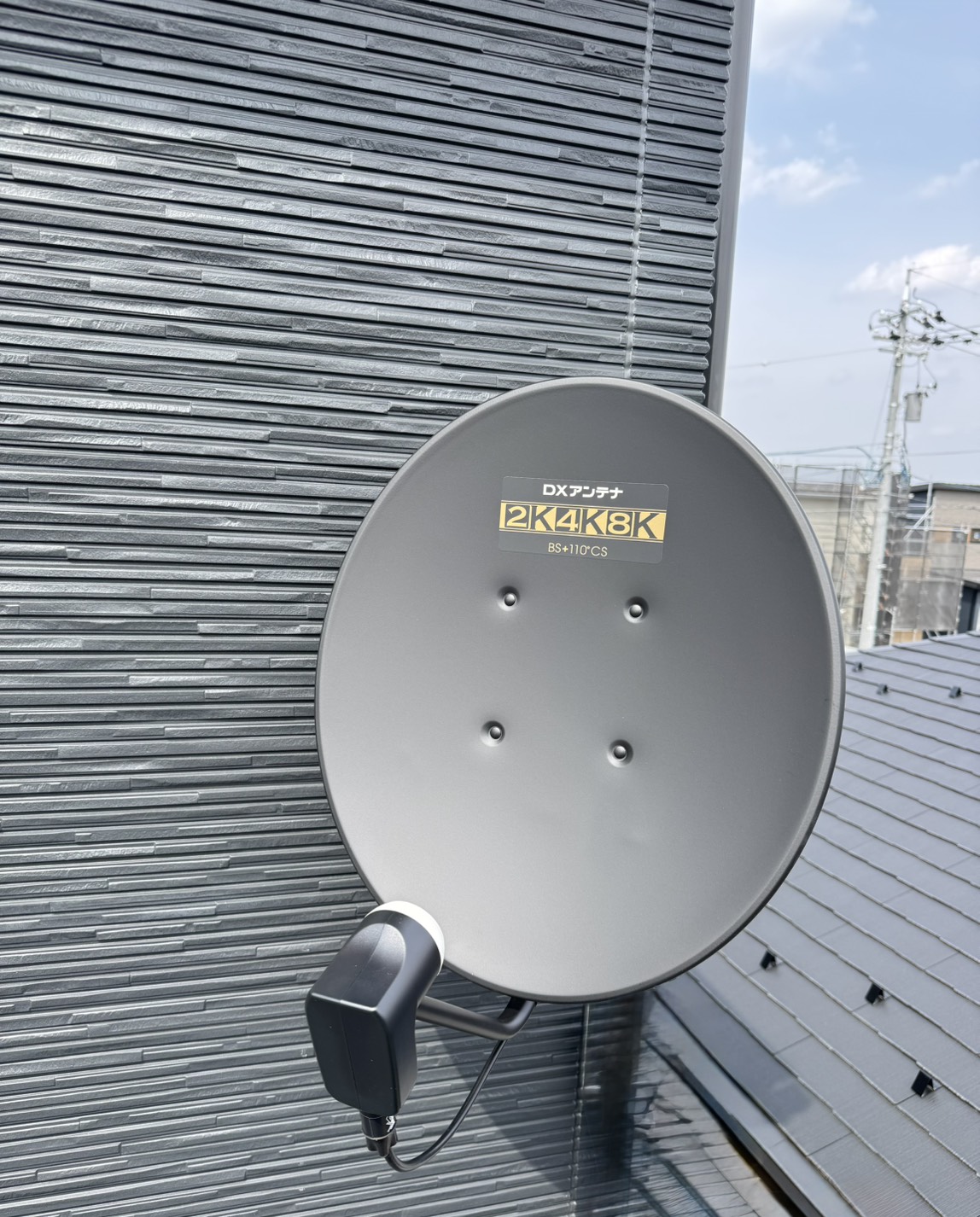 外壁に設置されたブラックのBSアンテナ(2K4K8K対応)
